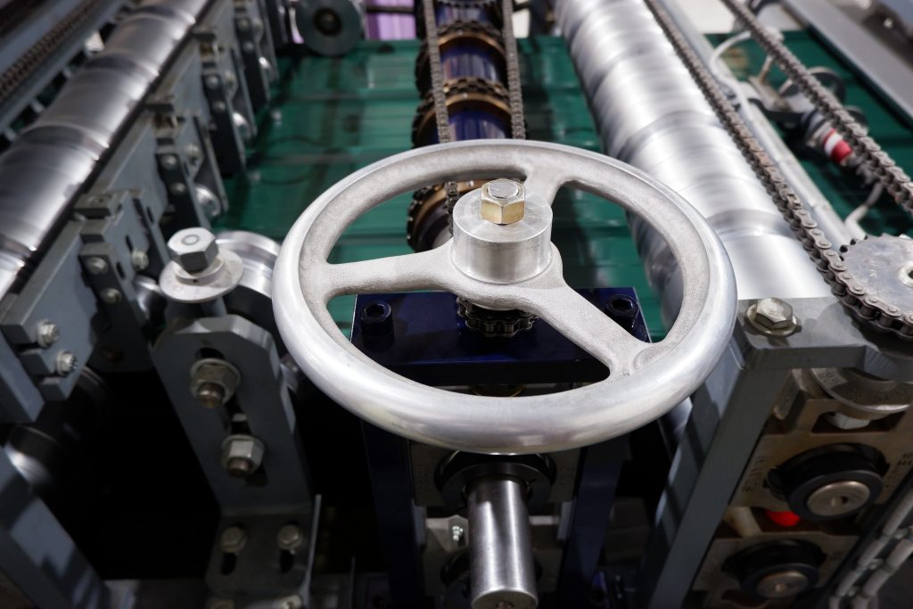Adjustment handwheel on custom soffit punching machine — metal fabrication equipment built in Liberty, KY