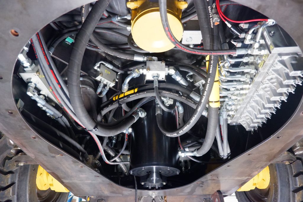 Bottom up vies of hydraulic hoses and equipment carriage.
